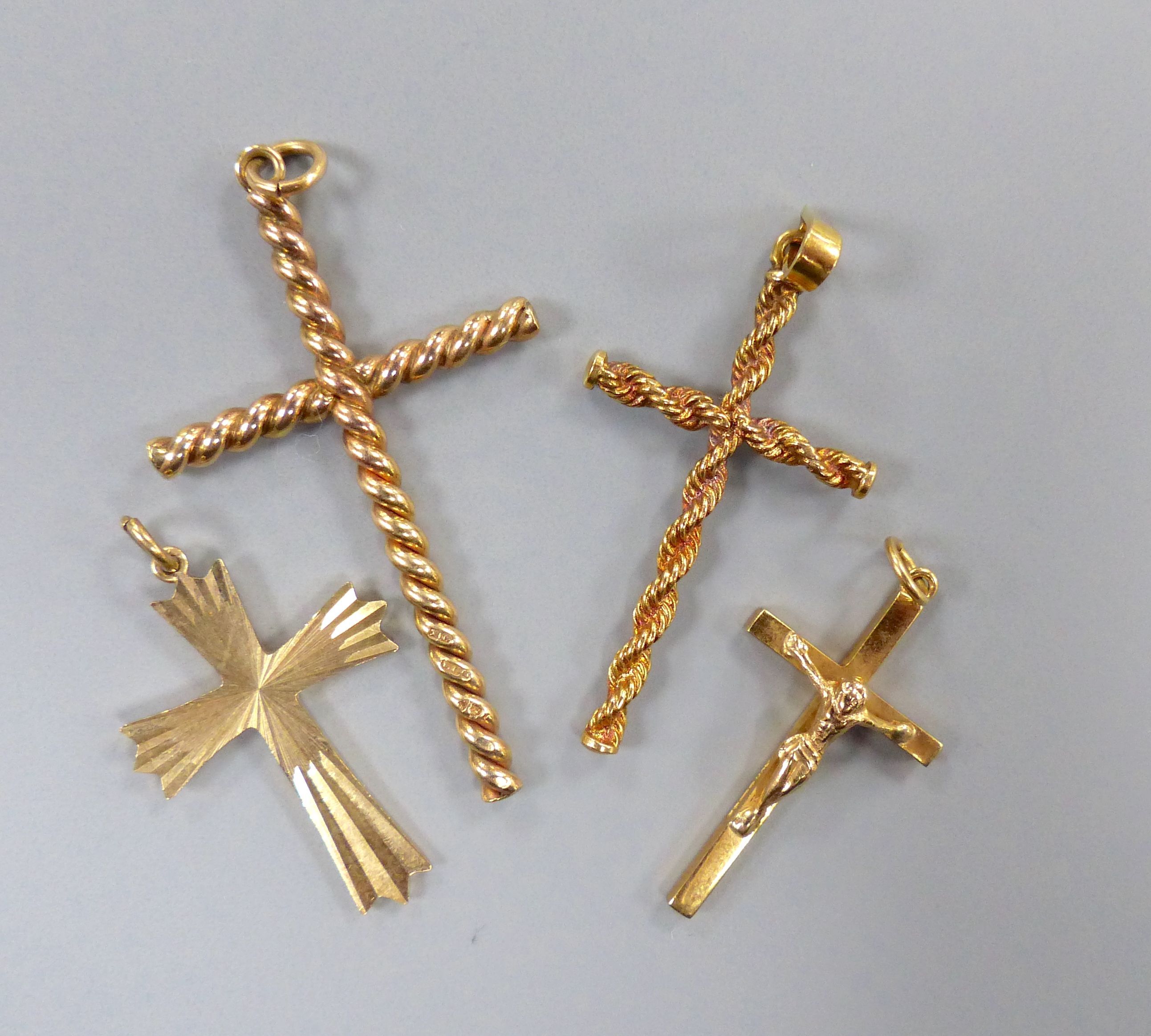 Four assorted modern 9ct gold cross pendants, largest 43mm,